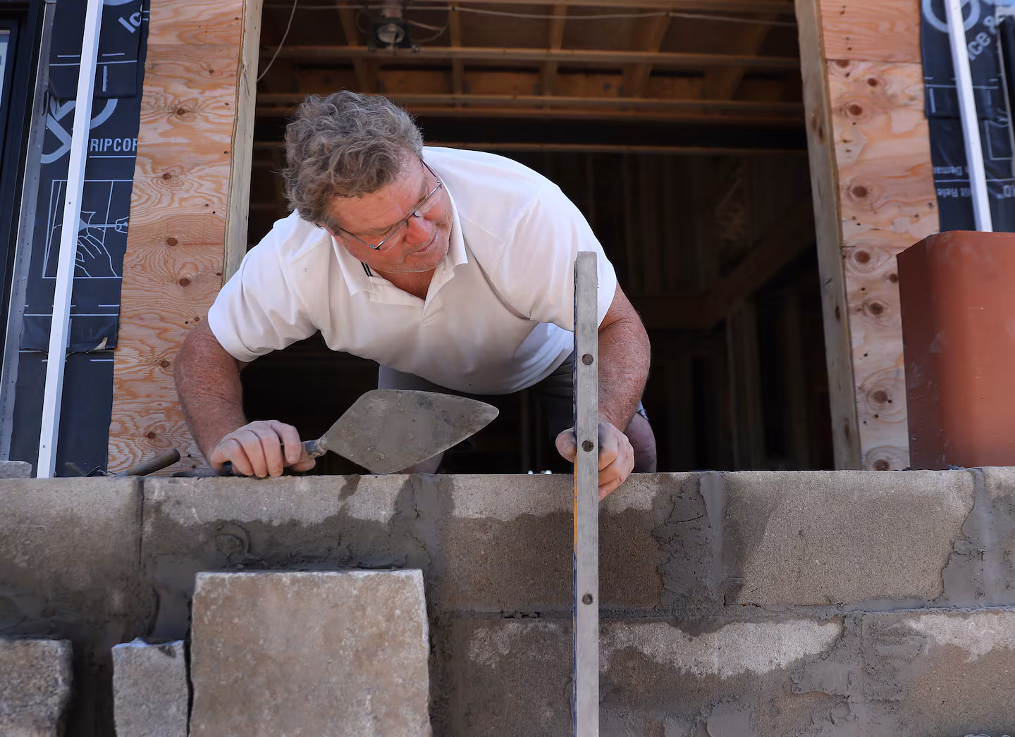 Marty Nally laying stone on a North Shore job site